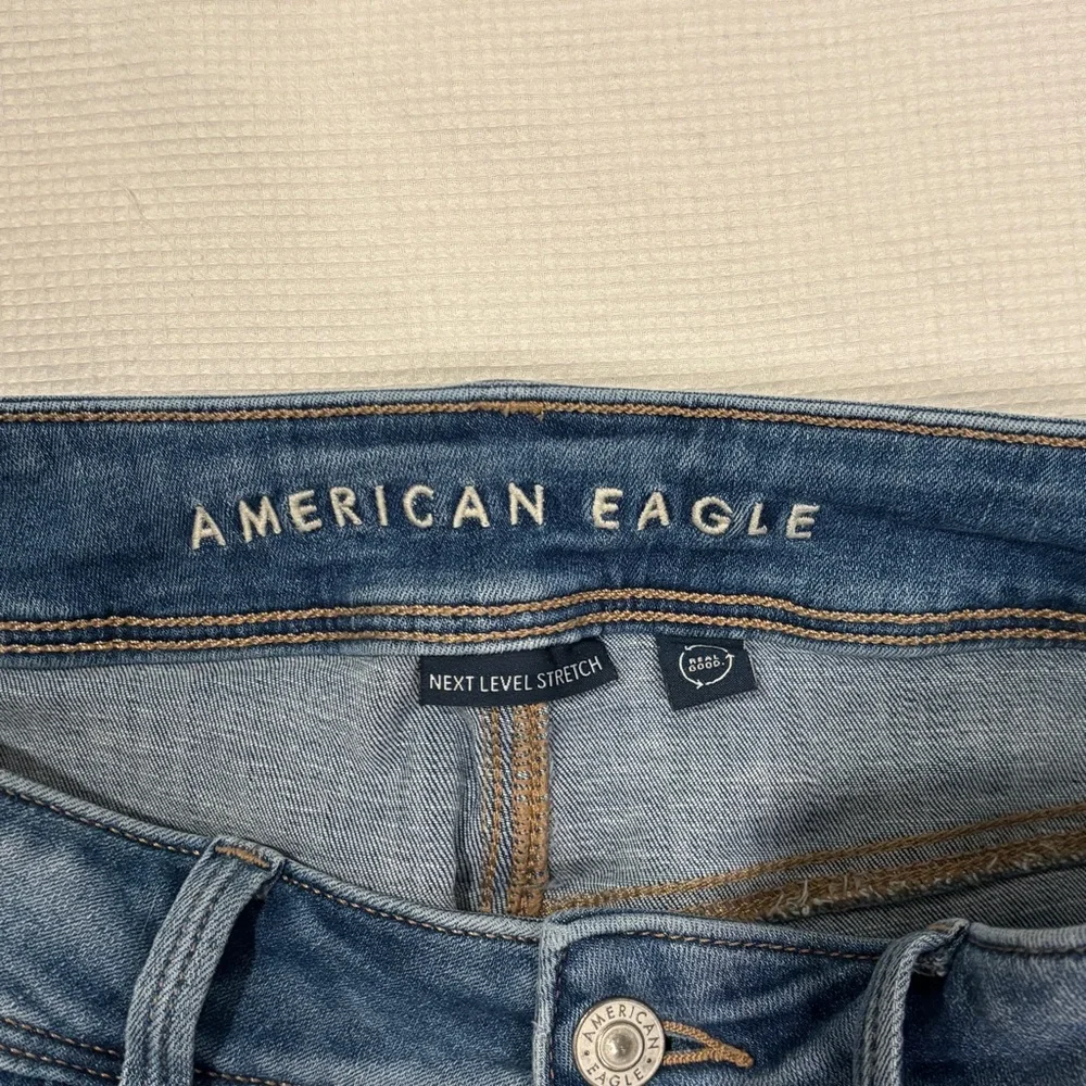American Eagle Next Level Stretch High Rise Kick Boot Jeans in Light Wash Denim - Picture 5 of 12